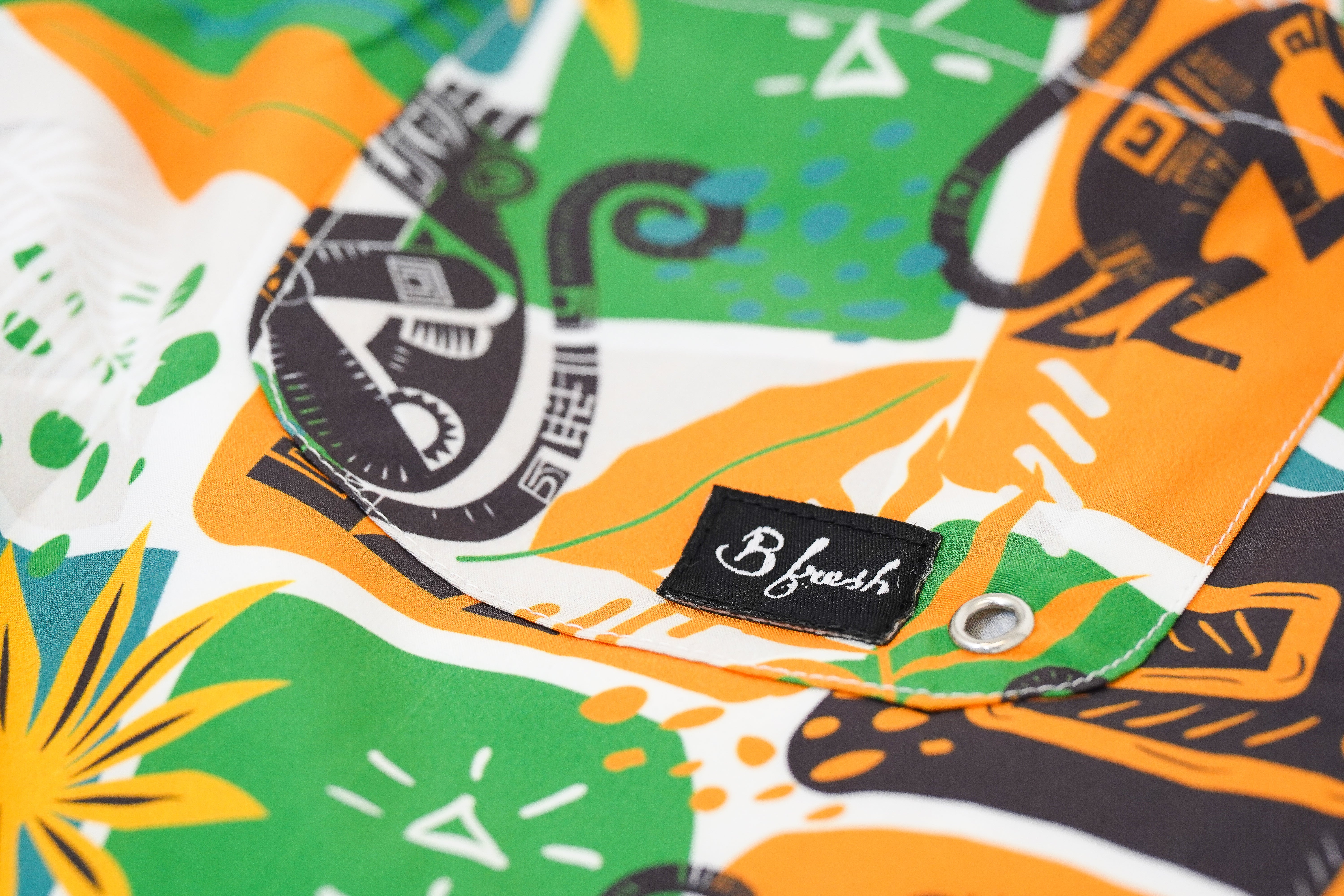 Colorful fabric with abstract monkey patterns and a B Fresh Gear 