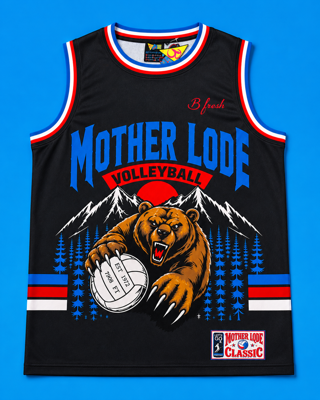 A black sleeveless basketball-style jersey with red, white, and blue trim, featuring a large graphic of a brown bear holding a volleyball in front of mountains and pine trees. The front text reads 'MOTHER LODE VOLLEYBALL' and includes a small 'B fresh' logo near the upper chest.
