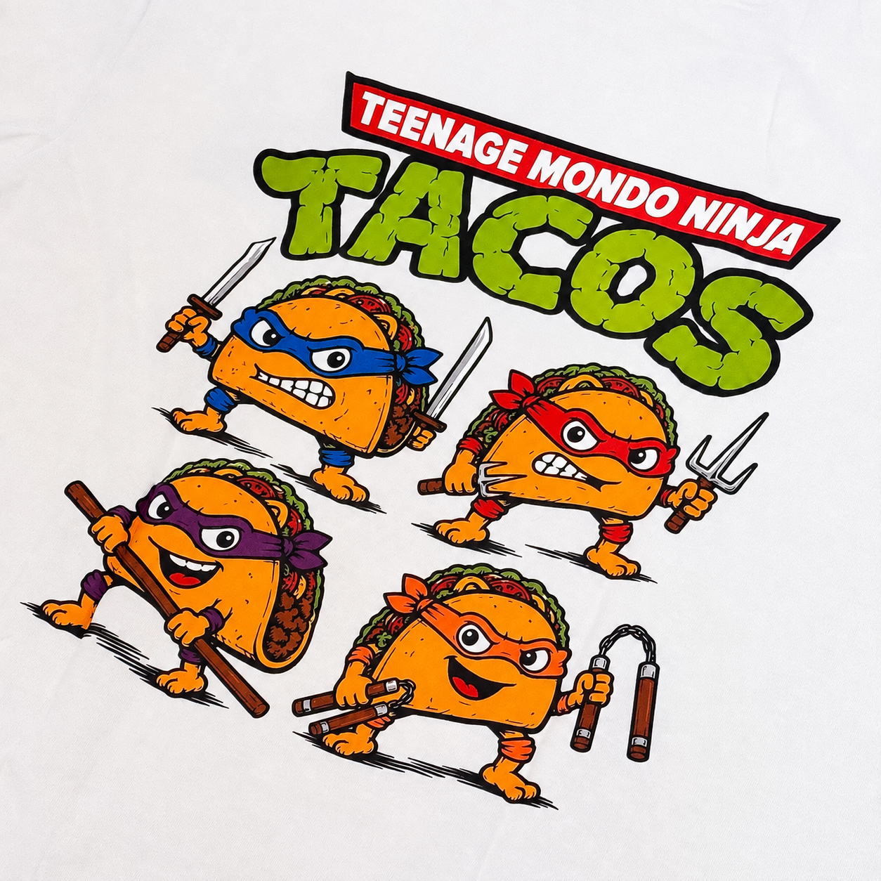 A white t-shirt featuring a colorful graphic print of the Teenage Mondo Ninja Tacos. The graphic shows four cartoon tacos styled like the Teenage Mutant Ninja Turtles, each with a different colored mask and weapon, beneath the bold green and red text 'TEENAGE MONDO NINJA TACOS'.