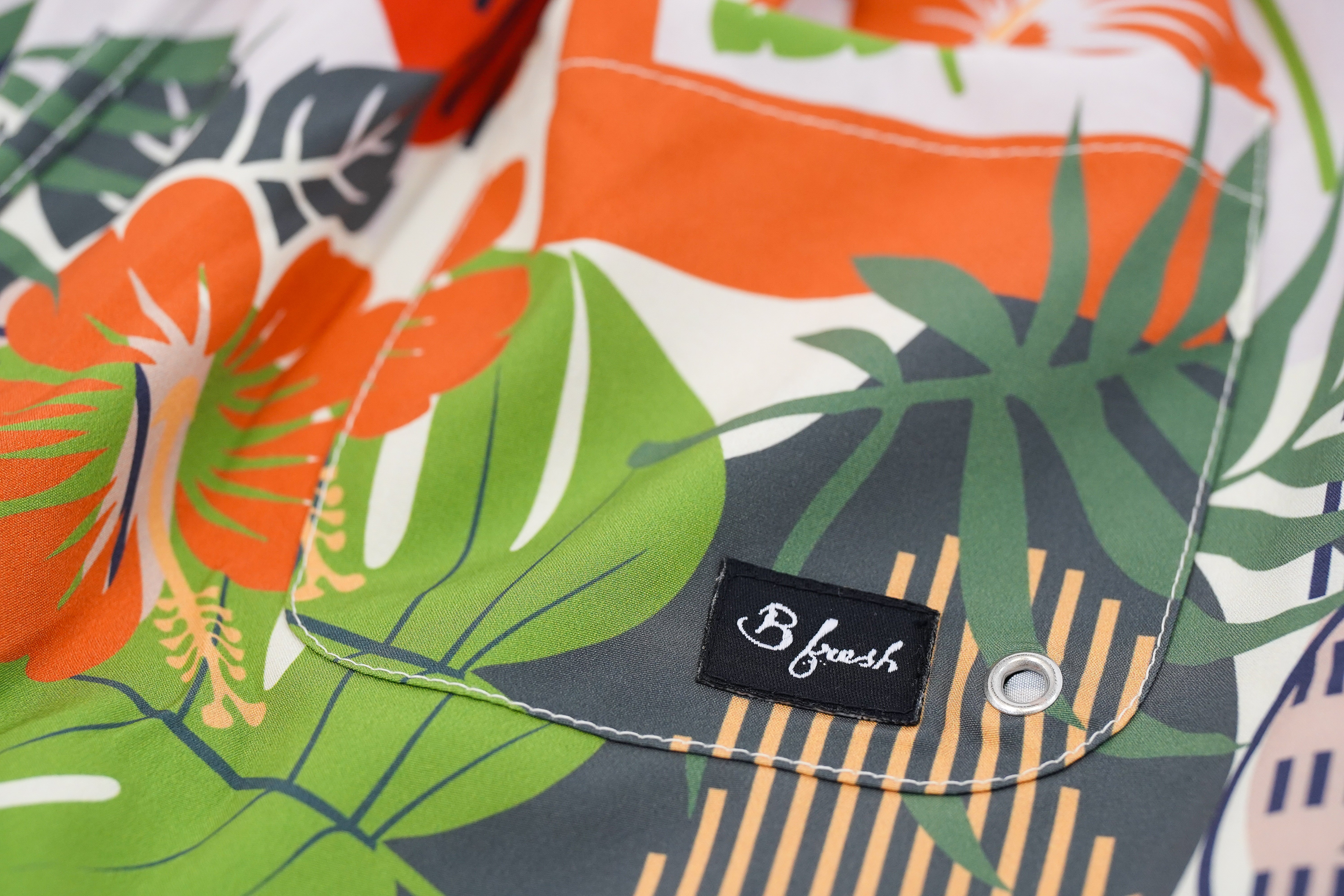Hawaiian shorts with tropical leaf pattern and 'B fresh' label.