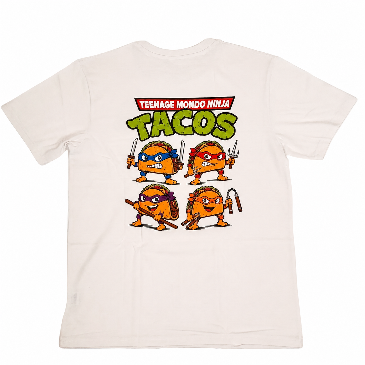 A white crewneck t-shirt featuring a colorful graphic of the Teenage Mutant Ninja Turtles characters stylized as tacos on the front