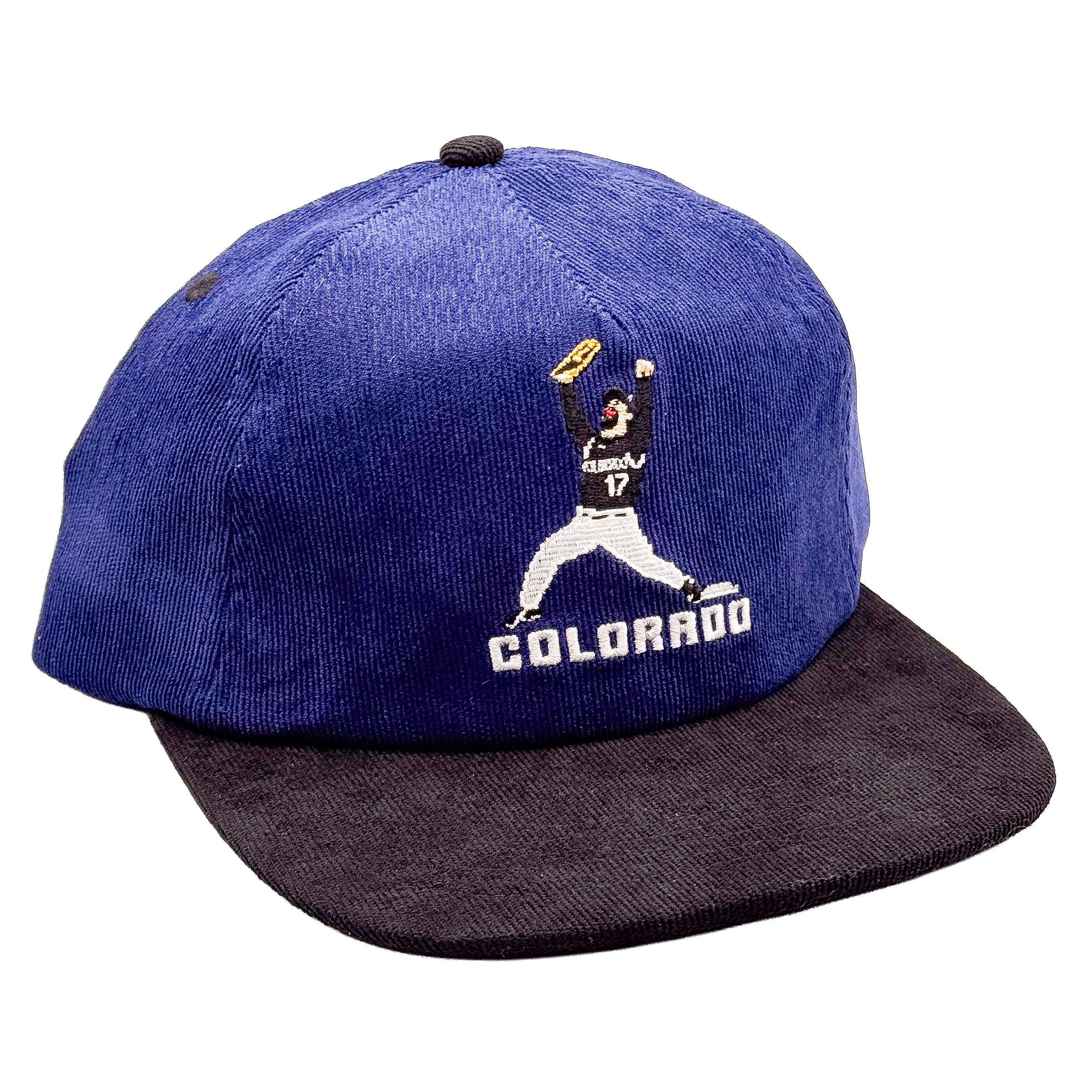 A Indigo corduroy baseball cap with a dark charcoal flat brim, featuring an embroidered Colorado Rockies Todd Helton 