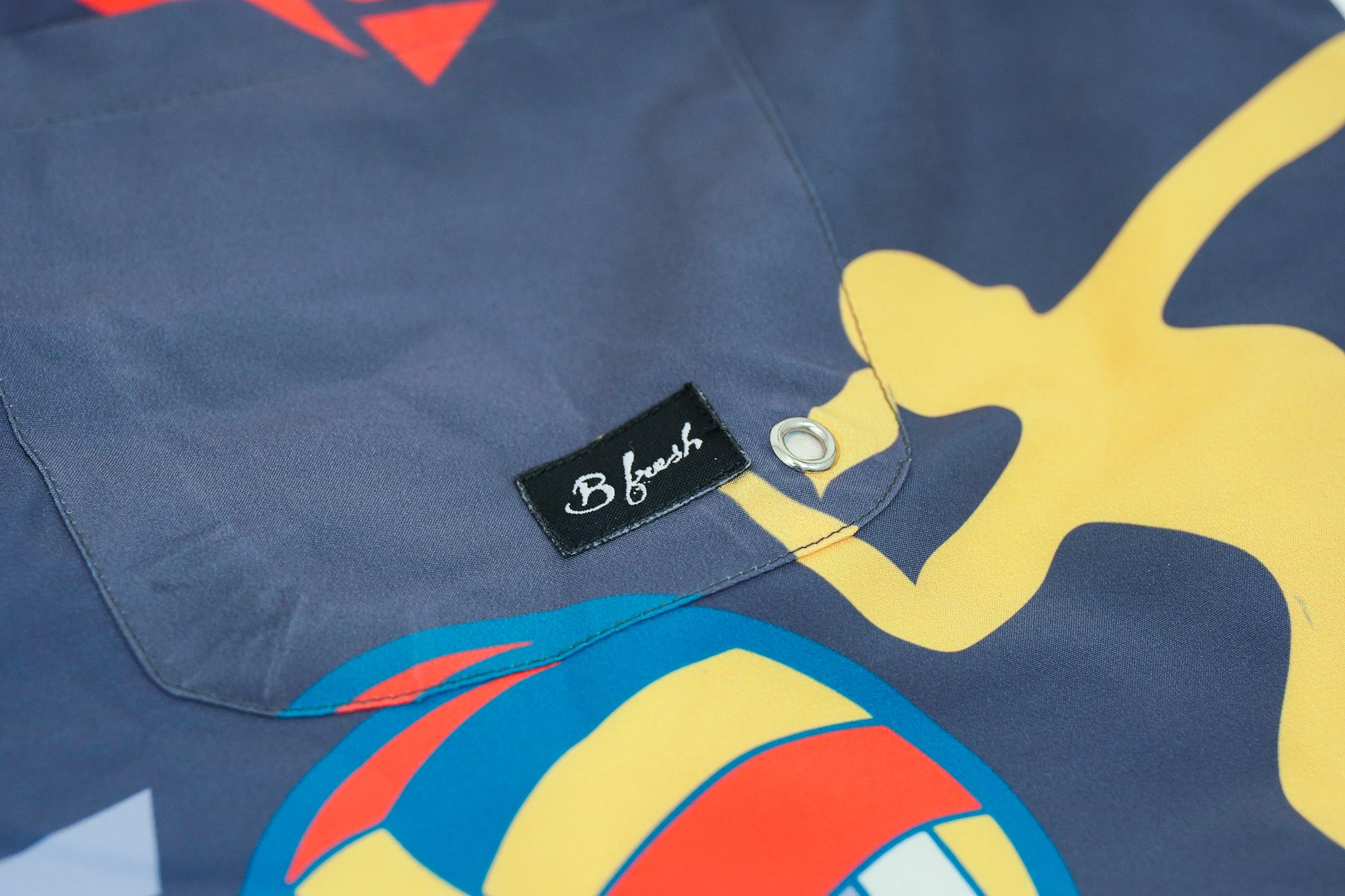 Close-up of a blue shirt with colorful graphic design 