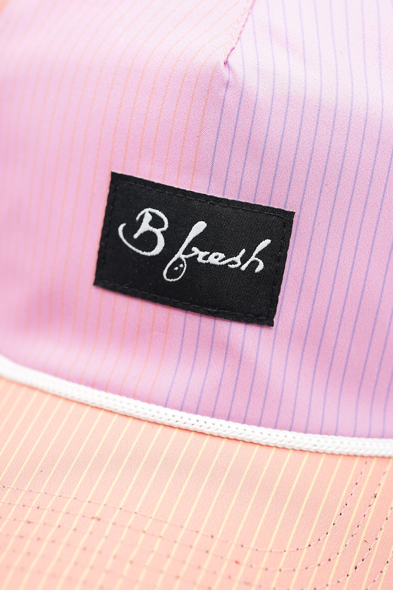 Close-up of a pink shirt with a 'B fresh' label.